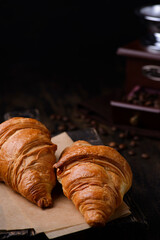 croissants on a wooden board on a brown background