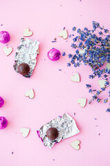 Valentine's day background. row of wooden hearts on a pink background, side view of a branch of dry lavender. Valentine's day concept. Top view, place for an inscription, advertising