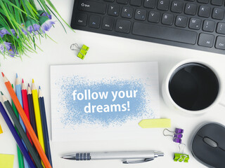 Follow your dreams word cloud handwriting on a notebook with a cup of coffee on office workspace. organizer mockup concept for blog or header image with space for text or copy space