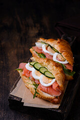 croissants on a wooden board on a brown background