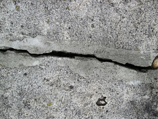 Broken concrete slab. Crack in stone material.