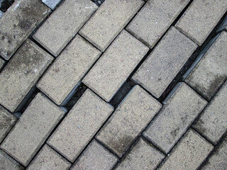Broken road tiles. A crack in a new pedestrian installation.