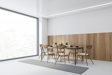 White and wooden dining room with chairs and table near window