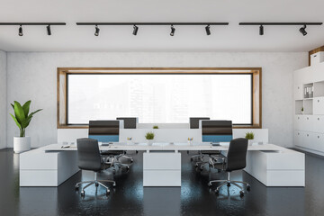 White office room with armchairs and computers on tables with window