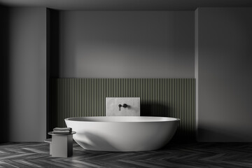 Obraz na płótnie Canvas Grey and green bathroom with white bathtub, parquet floor and grey wall