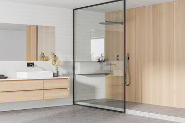 Fototapeta na wymiar Interior of stylish bathroom with wooden walls, concrete floor, double sink with horizontal mirror and shower stall.