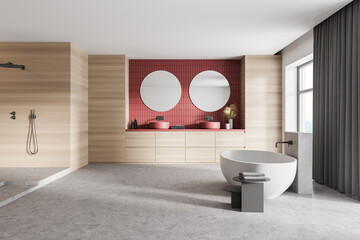 Wooden light bathroom with white bathtub, shower and sinks near window