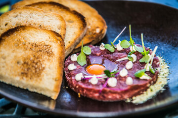 Beef tartare with crispy toast. The food in the restaurant. Food styling and restaurant meal serving.