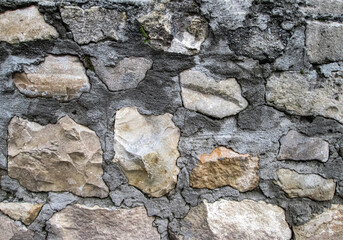 Painted stones in the wall. Road surface texture.