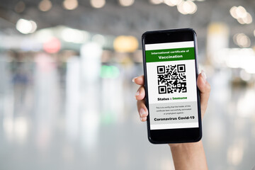 Traveler shows health passport of vaccination certification on phone at airport, to certicy that have been vaccinated of coronavirus covid-19
