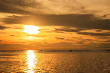 View of sunset at the sea with cockle farm.