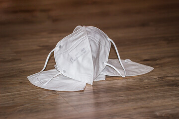 White respiratory mask N95 FFP2 on a wooden background close-up. Coronavirus Medical Protection Concept. Protective masks. Protection against pollution, virus, flu and corona virus.