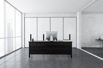 Grey office cabinet with black table and computer on marble floor