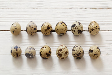 quail eggs on white wooden background