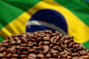 Roasted coffee beans on the background of the Brazilian flag, close-up, selective focus. Concept: best flavored coffee, export and import, delivery from the producing countries,