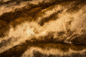Abstract yellow golden creasy velvet fabric background texture