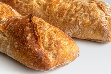 Crisp golden crust of a fresh mini baguette from a French bakery