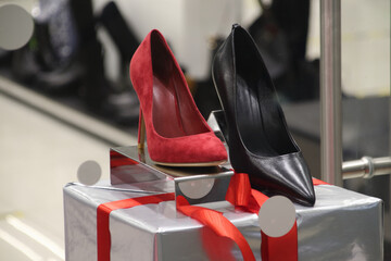 Shoe store selling womens heels stiletto red and black stands on shelf