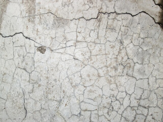 Fototapeta premium Many small cracks on the light stone slab. Broken hard floor surface.