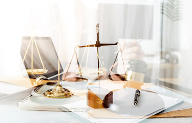 Business and lawyers discussing contract papers with brass scale on desk in office. Law, legal services, advice, justice and law concept picture with film grain effect