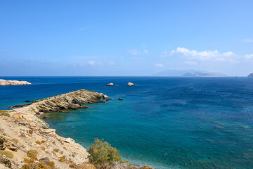 Fototapeta na wymiar Latinaki beach in the area of Karavostasi, small beach of sand mixed with rocks. Folegandros island, Cyclades, Greece