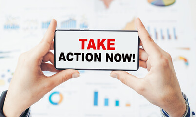 Closeup on businessman holding a smartphone with text TAKE ACTION NOW!