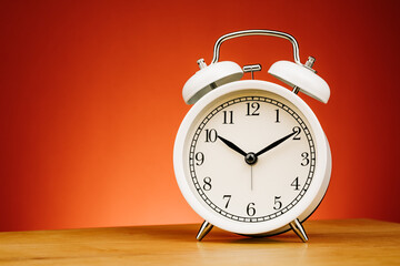 Vintage alarm clock on red background