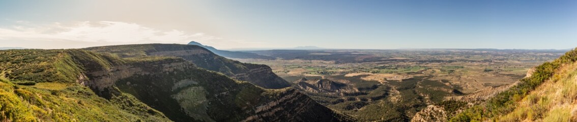 Panorama shot of view to flat valley of america nature from cliff of mesa verde at sunny day