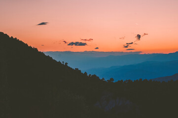 Mountains, trees and romantic sky at sunset.	