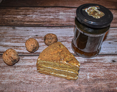 Baked cake with honey and walnuts on wooden table