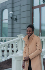 young African American in winter against the backdrop of a majestic building