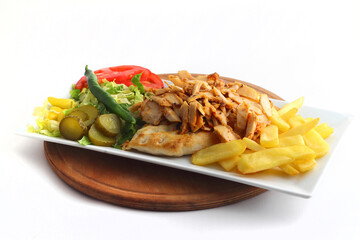 Turkish cuisine. Doner kebab meat with pommes frites potatoes and salad on plate isolated on white background
