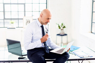 Thinking businessman working in the office