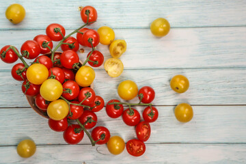 Fototapeta na wymiar Cherry tomatoes on wooden background