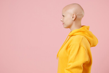Side profile view young bald caucasian nice cute woman 20s without hair with alopecia wearing...