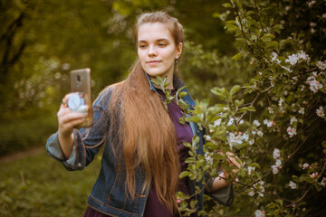 A girl takes a selfie on her phone