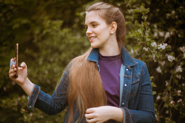 A girl takes a selfie on her phone