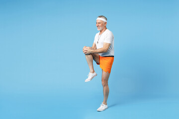 Full length elderly gray-haired sportsman trainer instructor man 50s in sportswear white t-shirt...