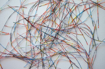 Abstract colorful threads pattern on white background.