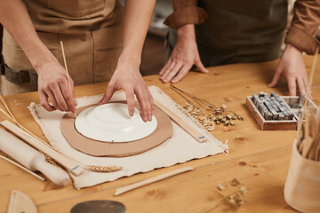 Obraz na płótnie Canvas Close up of unrecognizable male artisan making ceramics in pottery workshop, copy space