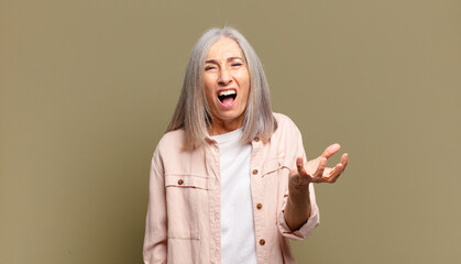 senior woman looking angry, annoyed and frustrated screaming wtf or what’s wrong with you