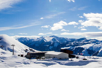 Fototapeta na wymiar Ski resort, snowy mountains and hostels.