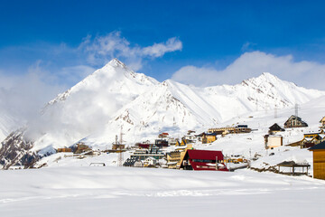 Ski resort, snowy mountains and hostels.