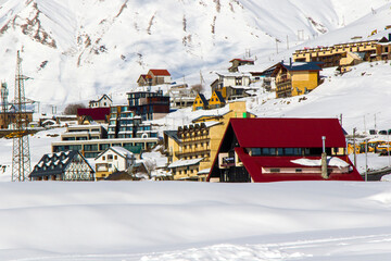 Ski resort, snowy mountains and hostels.