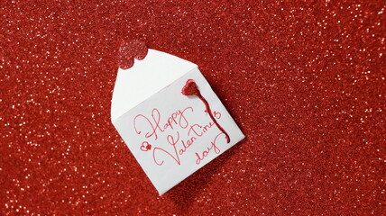 Valentines Day greeting concept .Open Envelope with red hearts on red shiny background