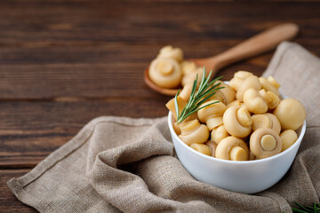 Pickled mushrooms - champignons in a bowl. Food preserving.