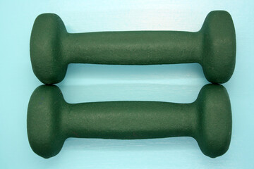 Dumbbells for exercise on a blue background.