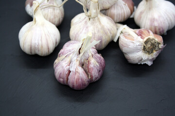Garlic heads on a black background.