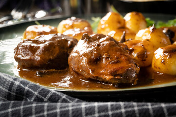 Traditional German braised pork cheeks in brown sauce.
