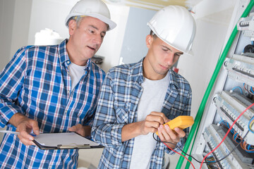 an electrician measuring the voltage